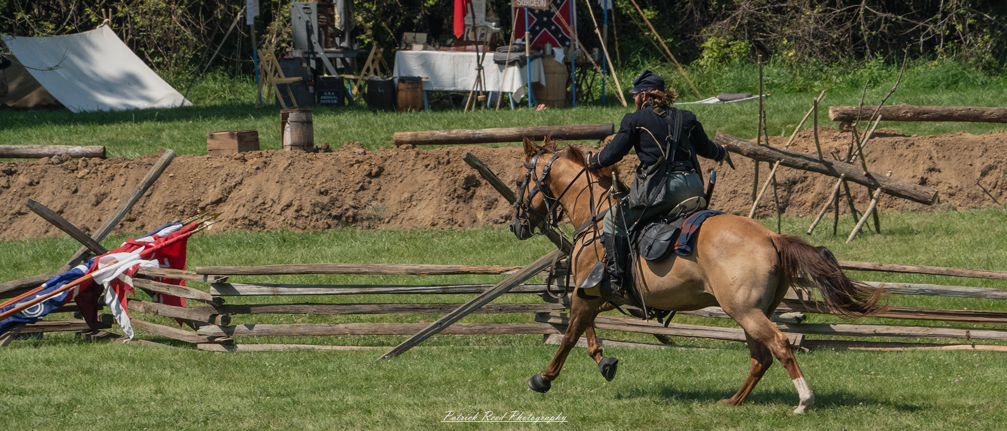 A cavalry soldier galloping on horseback, holding a pistol in one hand while maintaining control of the reins with the other. Dressed in a period uniform, the soldier's expression is determined, embodying the thrill and urgency of cavalry action in a dynamic battlefield setting.